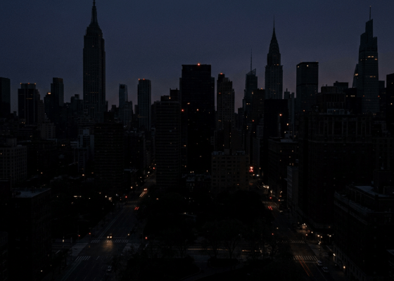 New York City skyline at night with illuminated windows and streets