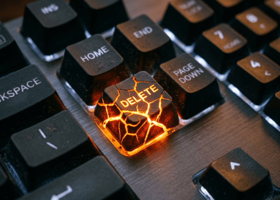 Keyboard with glowing cracked 'DELETE' key surrounded by 'HOME', 'END', and 'PAGE DOWN' keys