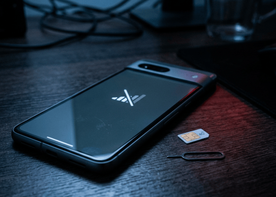 Smartphone beside a SIM card and SIM removal tool