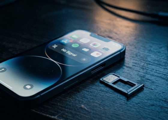 Smartphone showing “No Signal” beside a removed SIM card tray